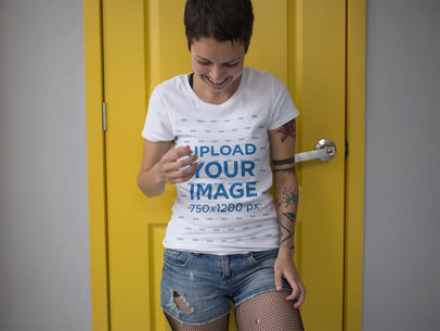 Alternative Woman Wearing a Round Neck Tee Mockup Against a Yellow Door