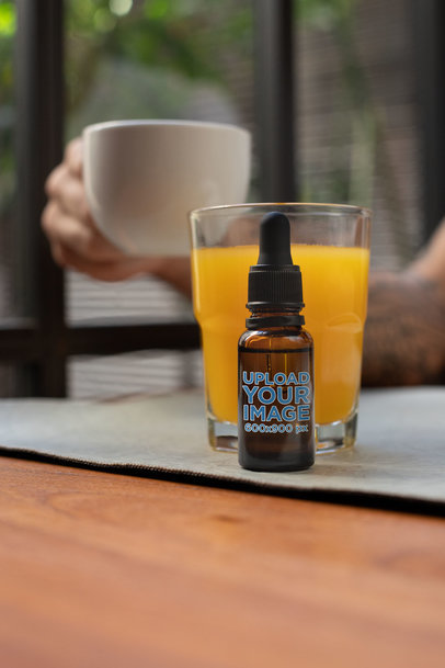 Mockup of a Dropper Bottle Placed on a Dinner Table 