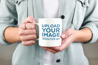 Mockup of a Woman Holding Her Coffee Mug 