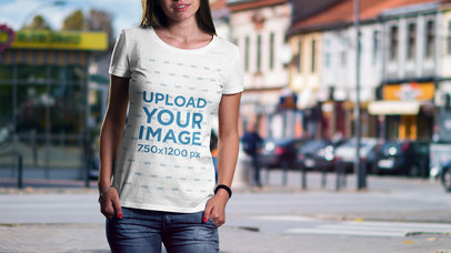 Mockup of a Woman Wearing a T-Shirt Featuring a City in the Background