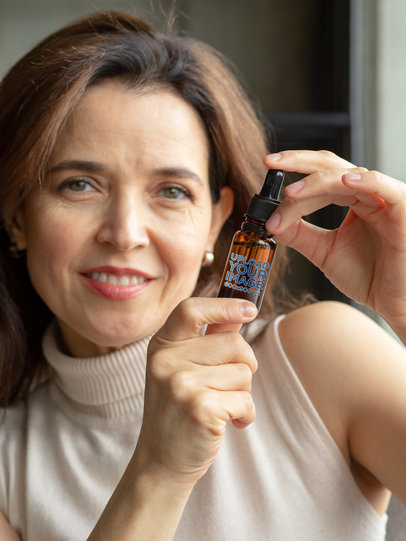Mockup of a Middle-Aged Woman Holding a Dropper