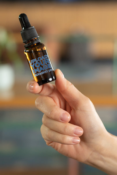 Mockup of a Woman Holding a Dropper