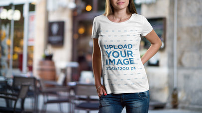 Mockup of a Woman Wearing a T-Shirt with a Restaurant in the Background