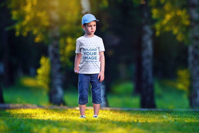 Mockup of a Boy Wearing a T-Shirt at the Park 