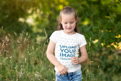T-Shirt Mockup of a Young Girl Playing in Nature