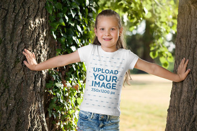 T-Shirt Mockup of a Little Girl Playing in the Woods