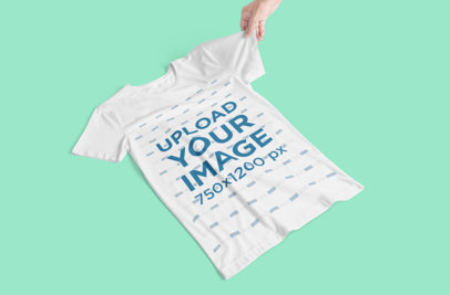 T-Shirt Mockup Featuring a Hand Holding a Tee Sleeve 