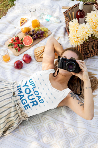 Tank Top Mockup of a Woman Lying by a Picnic Basket While Taking a Picture 