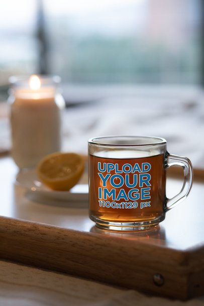 Mockup of a Glass Mug Placed Next to a Candle 