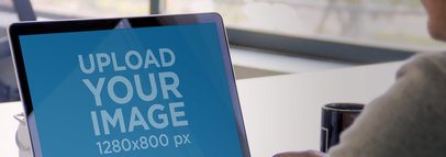 Mockup of a Man Using a MacBook at Work