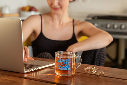 11 oz Clear Glass Mug Mockup Featuring a Woman Working at Home 