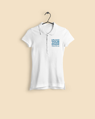 Mockup of a Women's Polo Shirt Hanging Against a Plain Backdrop