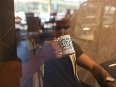 Young Man at a Coffee Shop Drinking from His Mug Mockup