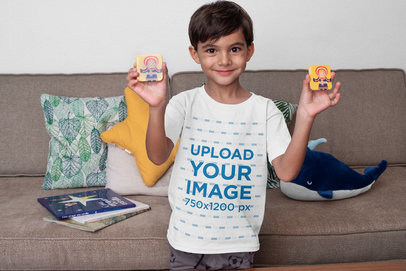 T-Shirt Mockup of a Smiling Boy Playing at Home