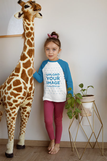 Raglan Tee Mockup Featuring a Girl Standing Next to a Stuffed Animal 