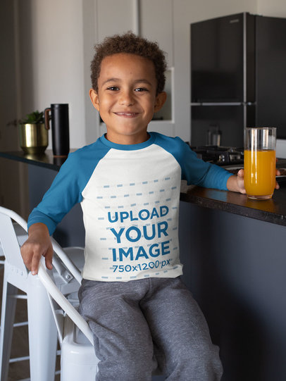 Raglan Tee Mockup of a Smiling Kid Drinking Juice