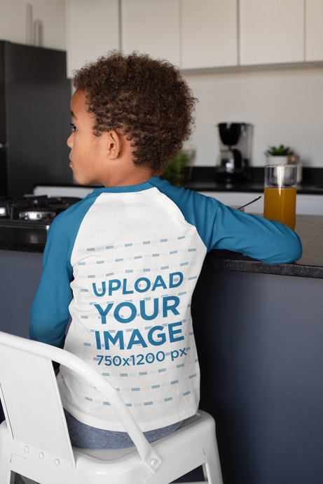 Back-View Raglan T-Shirt Mockup of a Boy Eating Breakfast