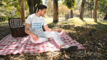 T-Shirt Video of a Man Feeding a Squirrel at a Park 