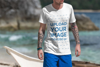 T-Shirt Mockup of a Tattooed Man Walking on the Beach