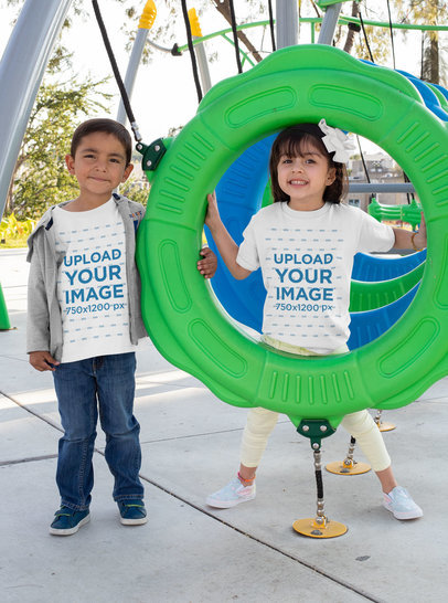 Mockup Featuring a Boy and a Girl Wearing T-Shirts at a Playground 