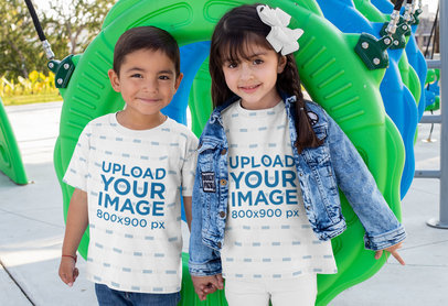 Sublimated Tee Mockup Featuring Two Smiling Kids at a Playground