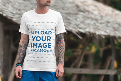 Mockup of a Tattooed Man Wearing a T-Shirt at the Beach