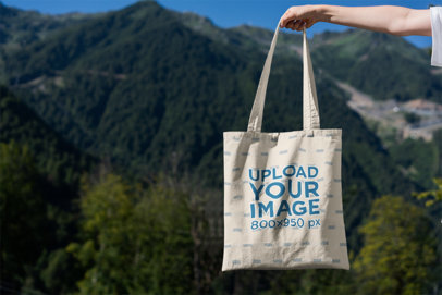 Tote Bag Mockup Featuring Mountains in the Background