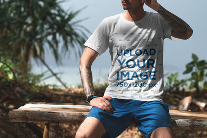 T-Shirt Mockup of a Man Relaxing at a Tropical Beach