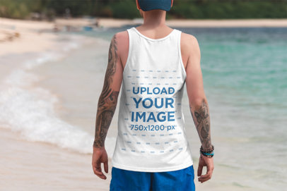 Back View Mockup of a Tattooed Man Wearing a Tank Top at a Tropical Beach 