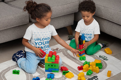 T-Shirt Mockup Featuring Two Siblings Playing with Blocks