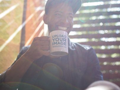 Mug Mockup of a Young Man Smiling at a Coffee Shop a12295