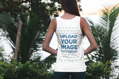 Back View Tank Top Mockup Featuring a Woman Standing By Some Palm Trees