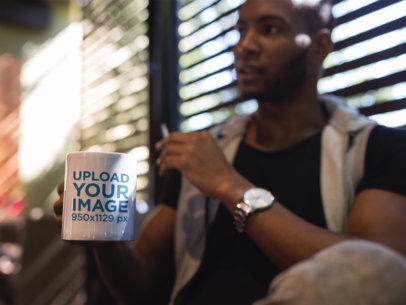 Man at a Coffee Shop Holding a Mug Mockup