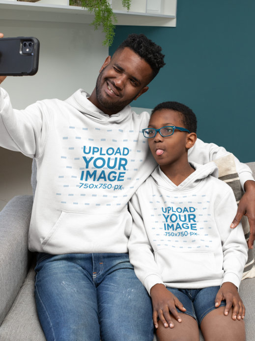 Mockup of a Dad and Kid with Hoodies Taking a Selfie