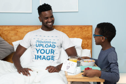 T-Shirt Mockup Featuring a Kid Serving Breakfast to His Dad 