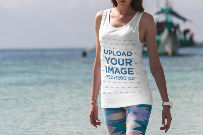 Tank Top Mockup of a Woman at the Beach with a Ship in the Background