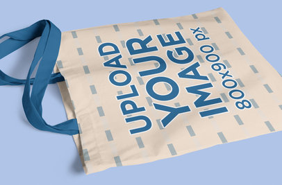 Mockup of a Sublimated Tote Bag wth Customizable Strap Placed on a Flat Surface