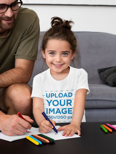 T-Shirt Mockup Featuring a Happy Girl Drawing With Her Dad