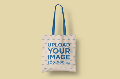 Mockup of a Customizable Tote Bag Placed Over a Plain Color Backdrop
