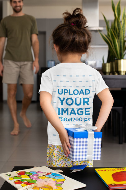 Back View T-Shirt Mockup Featuring a Little Girl Holding a Present for Her Dad 