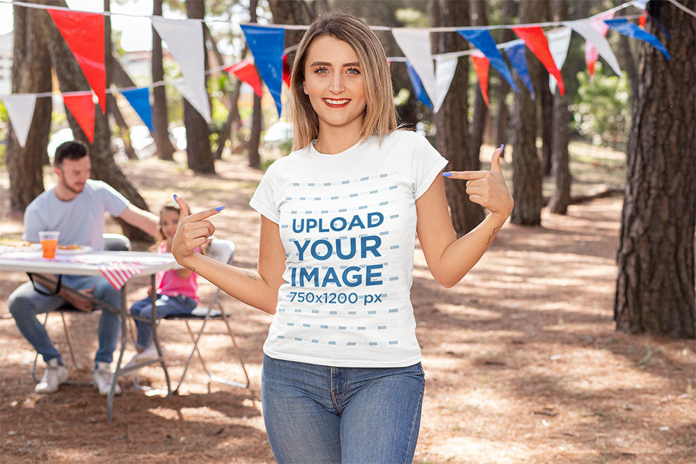 Mockup of a Woman Showing Off Her T-Shirt on a 4th of July Celebration