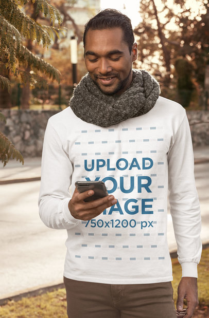 Long Sleeve Tee Mockup Featuring a Bearded Man Checking His Phone on the Street