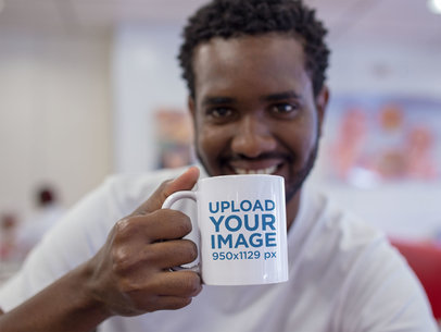 Young Man Smiling with his Mug at a Diner a12330