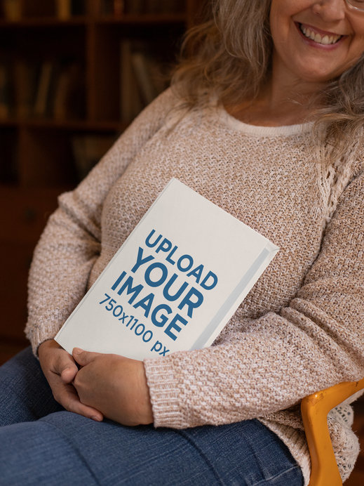 Mockup of a Woman Happily Holding a Book