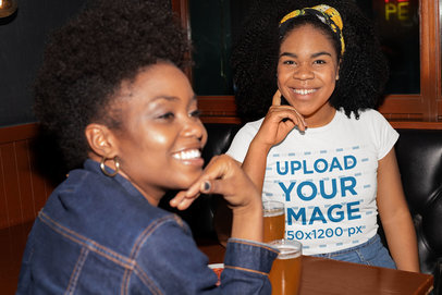 T-Shirt Mockup of a Woman at a Bar Talking to Her Friend 