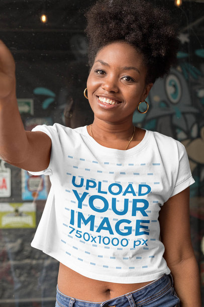 Selfie Mockup of a Smiling Woman Wearing a Crop Top Tee
