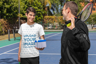 T-Shirt Mockup of a Man Giving a Present to His Dad After a Tennis Match
