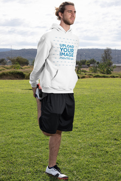 Pullover Hoodie Mockup of a Man Warming Up Outside