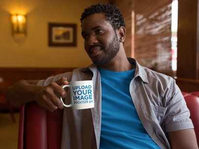 Young Man Having a Conversation and Holding a Mug Mockup a12323