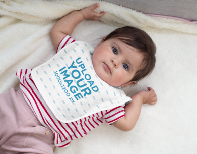 Baby Bib Mockup Featuring a Baby Girl Lying Down 